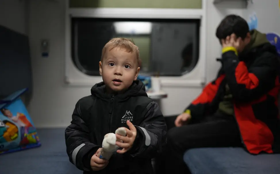 Ein Junge in einem zum Aufenthaltsort umgewandelten Zugwaggon | © UNICEF/Filippov Ukraine Krieg: Ein Junge in einem zum Aufenthaltsort umgewandelten Zugwaggon.
